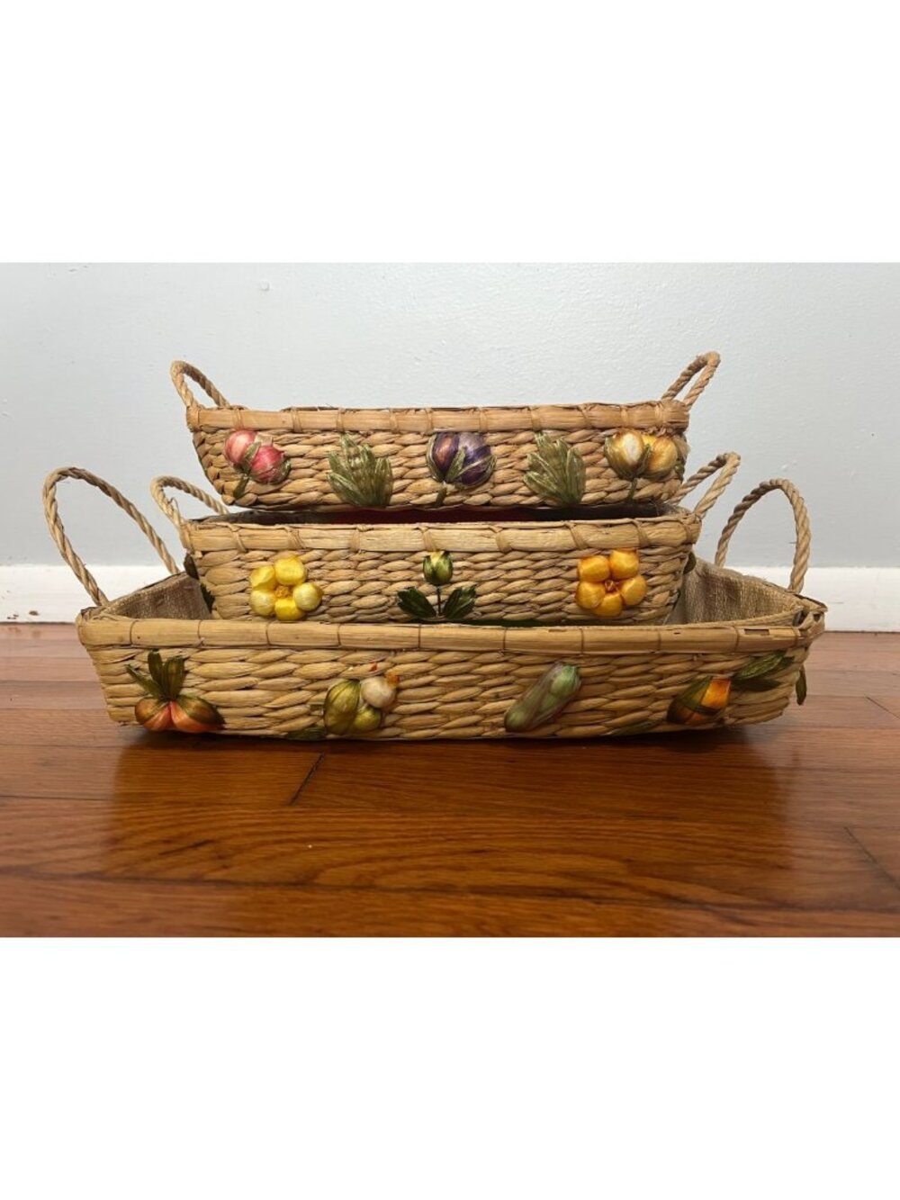 Nested woven straw and raffia baskets decorated with 3D fruits and vegetables